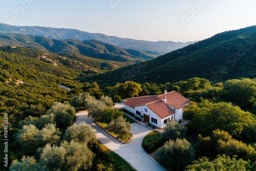 Set against a backdrop of rolling hills, this charming countryside home embodies tranquility, showcasing seamless integration of architecture with stunning natural landscape.