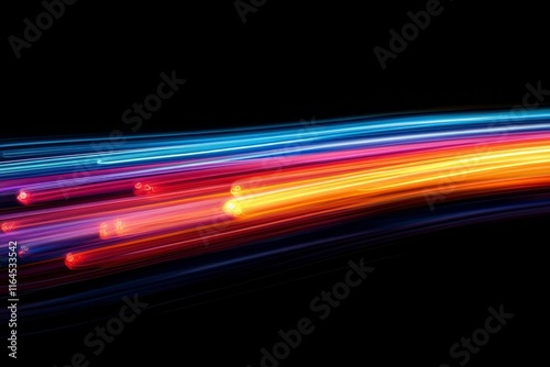 Vibrant light trails create dynamic patterns in a dark environment during nig...