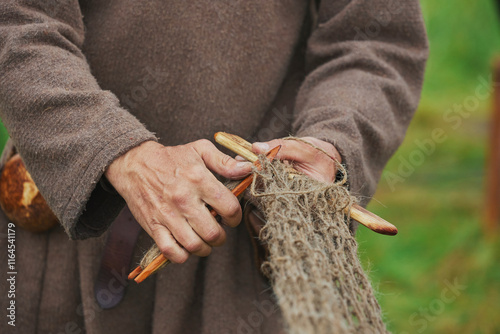 Fisherman weaving a net at a Viking festival in Denmark
