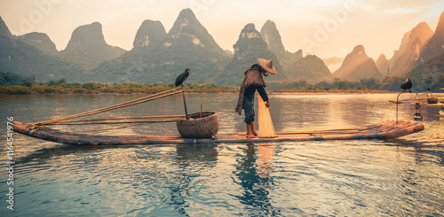 silhouette of a cormorant fisherman at sunsset