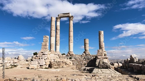 Ancient Roman Ruins Under a Bright Blue Sky with Clouds and Pillars