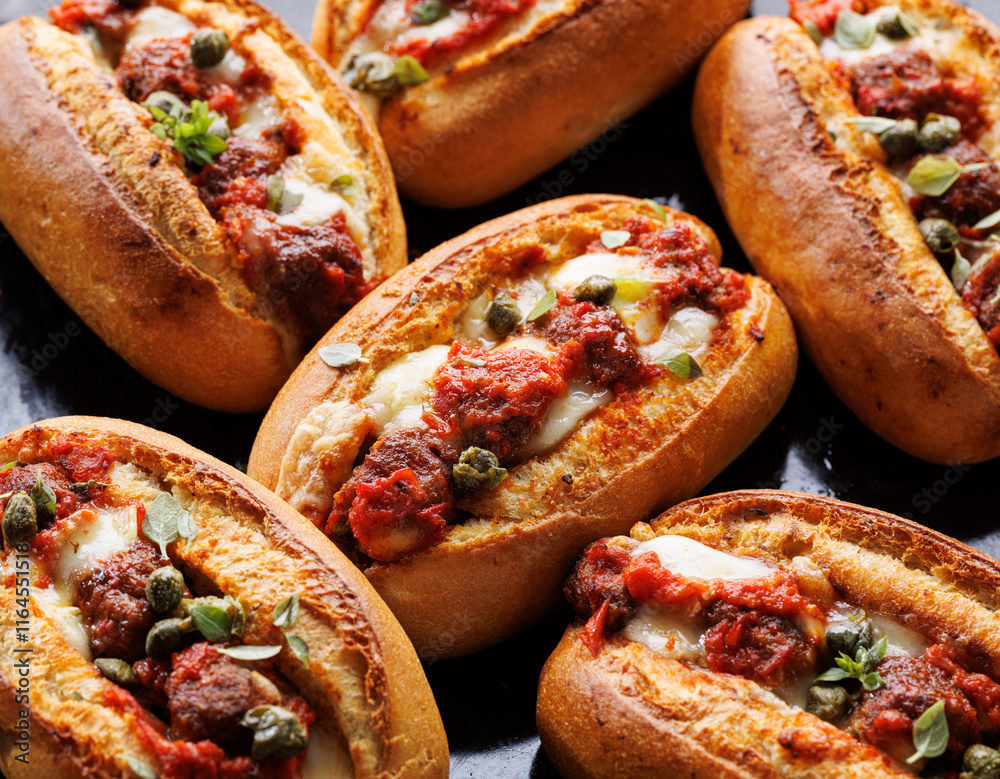 Meatball Sub Sandwiches on a dark background, focus on the middle, close up view Meatball Sub Sandwiches on a dark background, focus on the middle, close up view