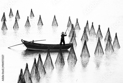 silhouette of a boat among fishing nets photo