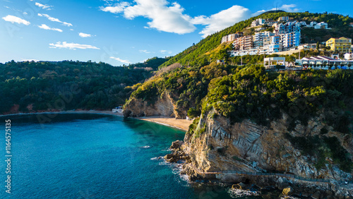 Budva, one of Montenegro's most popular coastal destinations, captured from the drone, offers a breathtaking aerial view of its historic Old Town, sandy beaches, and sparkling Adriatic Sea photo