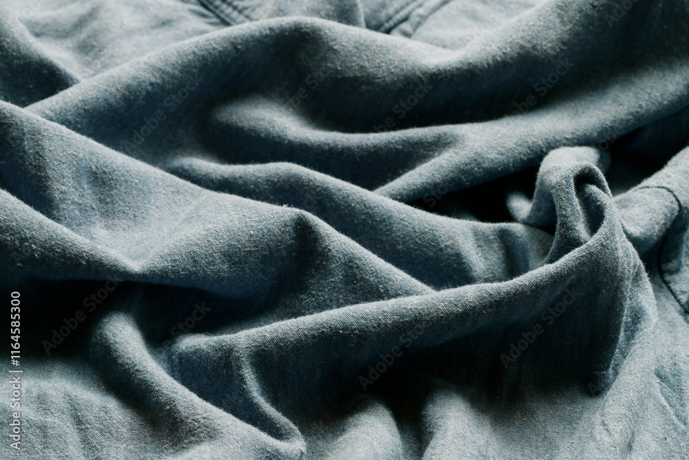 Abstract background with blue wavy linen fabric.