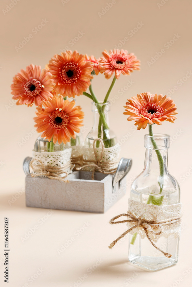 Simple decoration with gerbera flower in glass bottle.