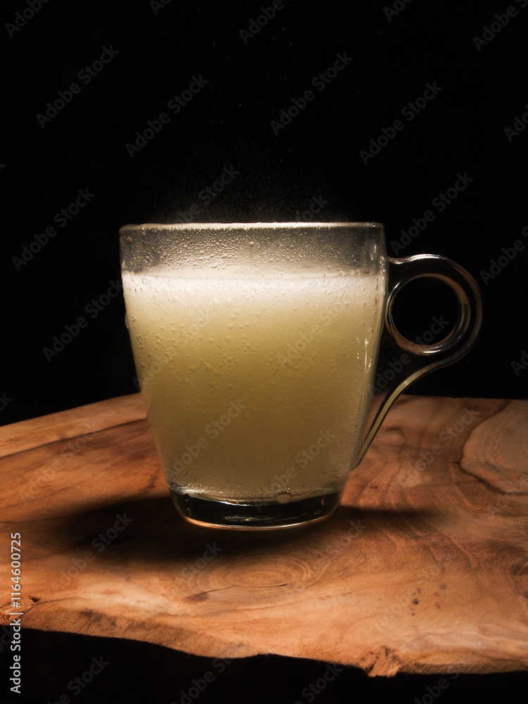effervescent tablet in glass on wooden board with black background. effervescent tablet in glass on wooden board with black background.