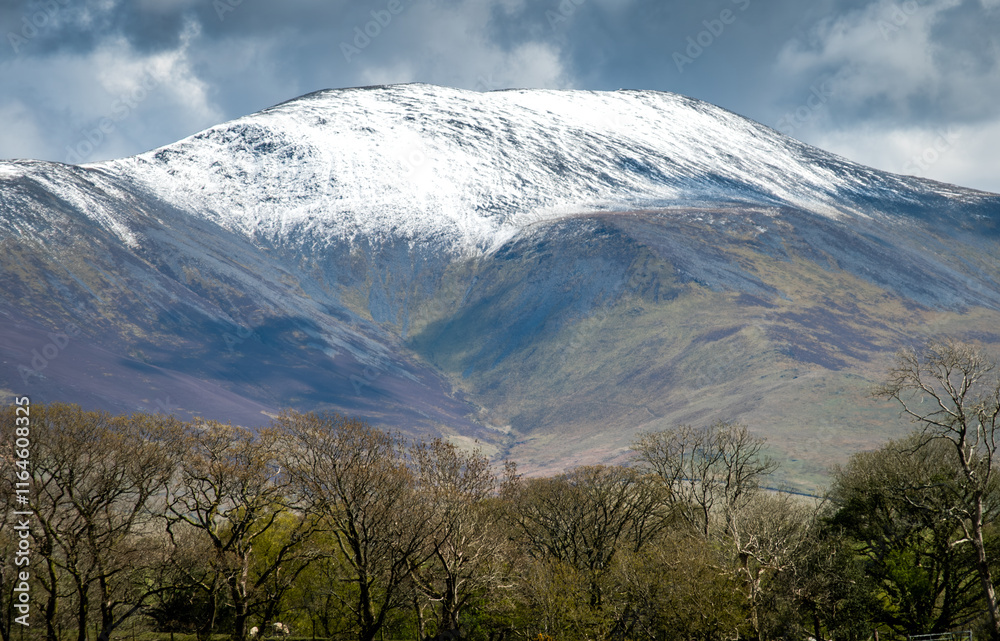 Mountain landscape with blue sky and snow capped hills Mountain landscape with blue sky and snow capped hills