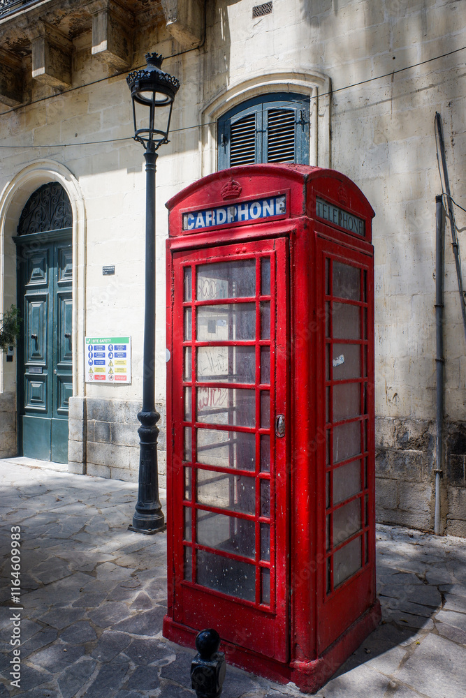 Traditional red telephone box in an historic town on the island of Malta Traditional red telephone box in an historic town on the island of Malta