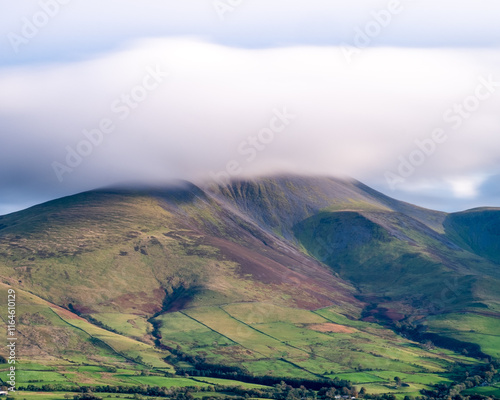 Landscape of mountains with clouds flowing over the peak photo