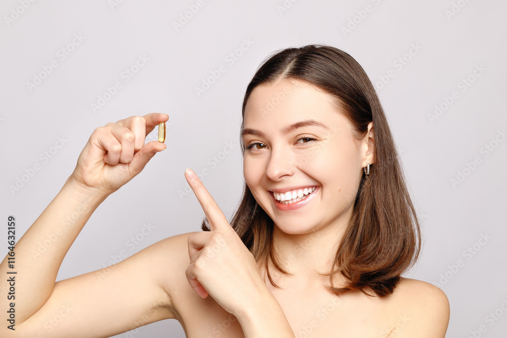 Beautiful Smiling Young Woman Holding Fish Oil Pill In Hand. Beautiful Smiling Young Woman Holding Fish Oil Pill In Hand.