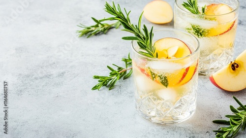 Refreshing apple cider fizz mocktail garnished with fresh rosemary and apple slices photo