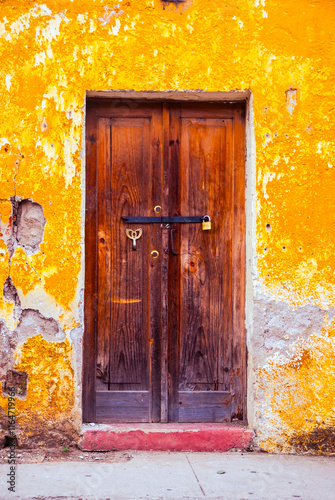 Door in a house in the colonial city of Antigua Guatemala, architectural space and entrance to a home, colorful and full of history with natural lighting.