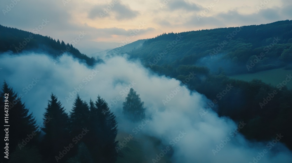 Fototapeta premium Aerial View of Smoke Rising from Mountainside at Dusk