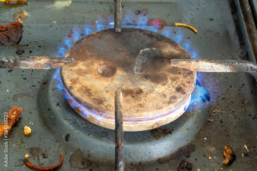 a dirty old gas stove in grease and soot photo