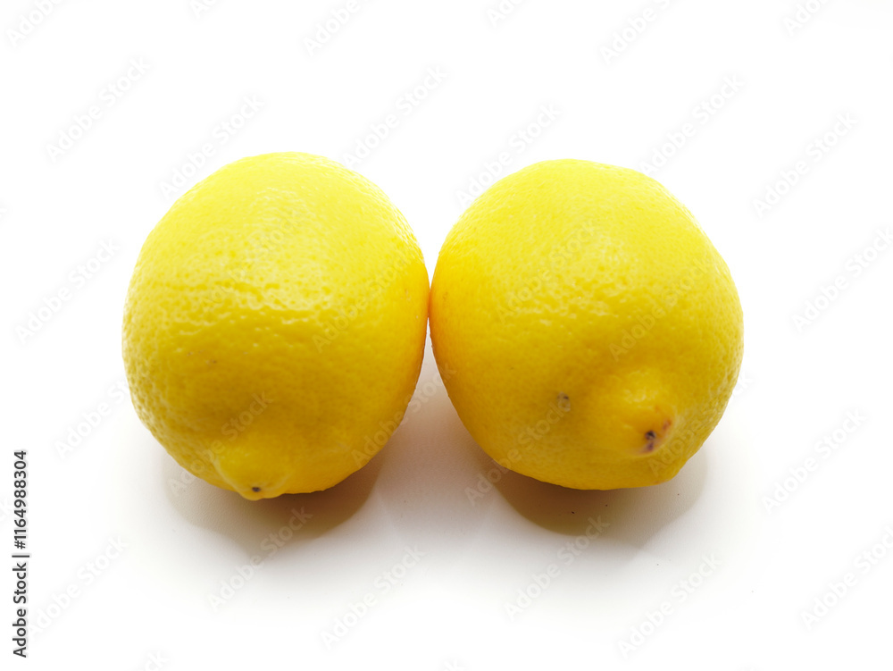 A vibrant yellow lemon sits on a pristine white background A vibrant yellow lemon sits on a pristine white background