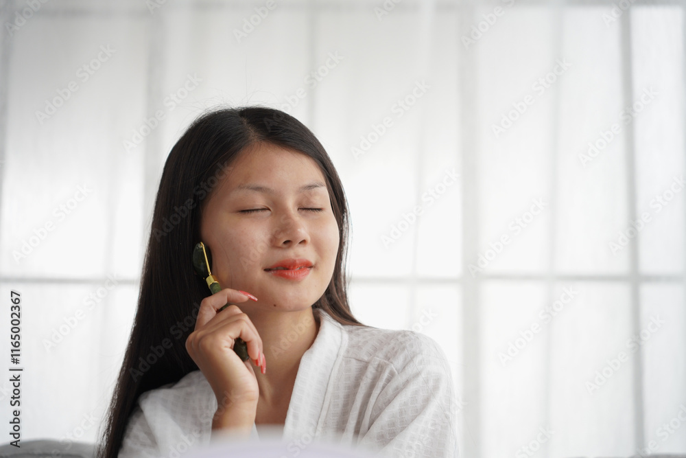 Asian woman in bathrobe applying skincare, take care of your facial skin Asian woman in bathrobe applying skincare, take care of your facial skin