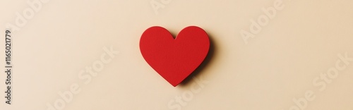 A simple red heart shape on a light beige background, symbolizing love and affection.