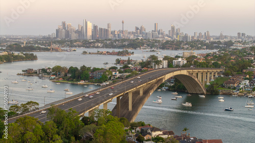 The gladesville bridge spanning the Parramatta river at Drummoyne with the Sydney skyline in the background. photo