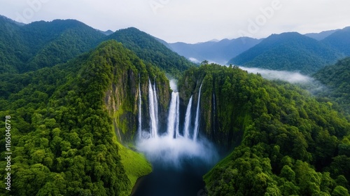 Aerial view of a stunning waterfall surrounded by lush mountains.