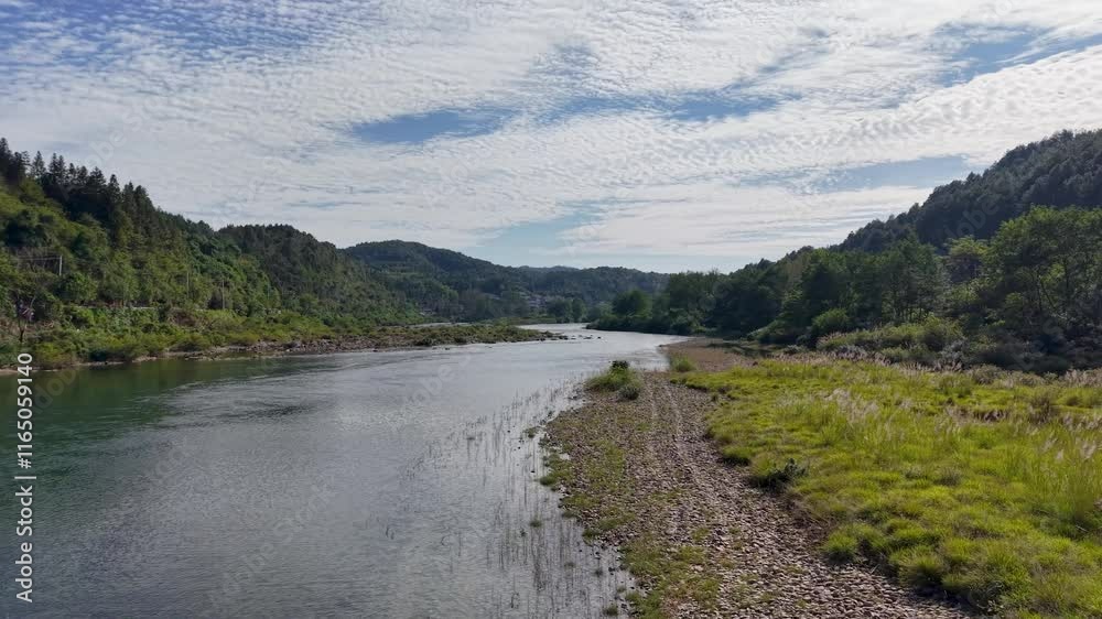 Explore the serene green mountain river flowing through stunning nature at dawn