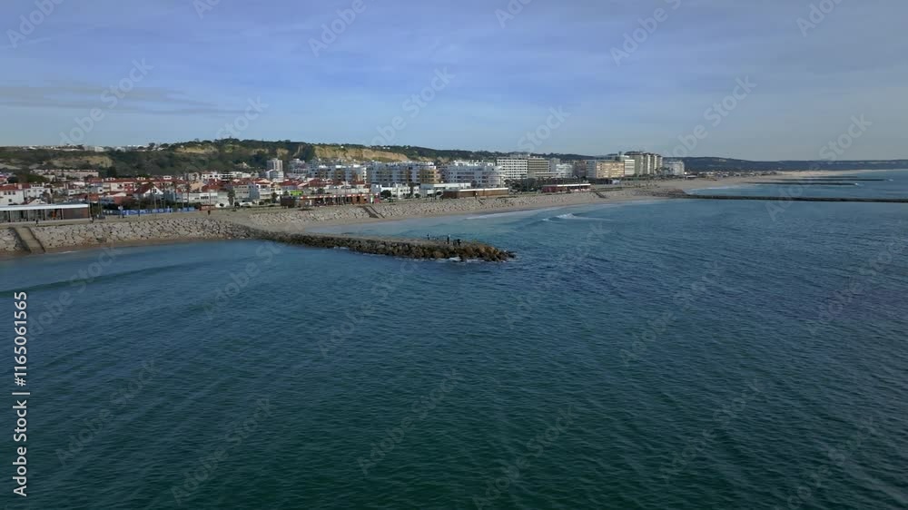 Low angle orbiting drone shot of a pier in Costa Da Caparica. Low angle orbiting drone shot of a pier in Costa Da Caparica.