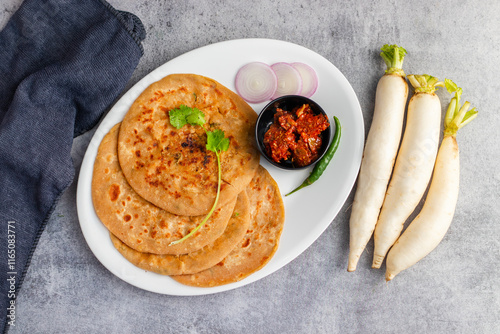Mooli paratha is a stuffed Indian flatbread made with grated radish, whole wheat flour, and spices, offering a flavorful, nutritious, and wholesome meal.