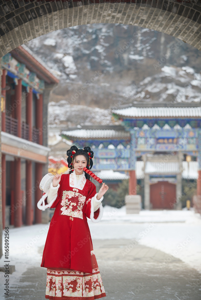 Obraz premium Asian girl wearing Chinese red Hanfu outdoors on a snowy day