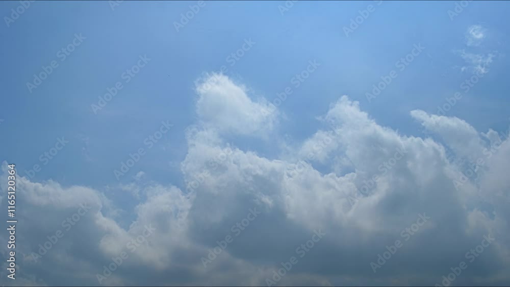 Beautiful time lapse of clouds drifting across a clear blue sky during daytime in a tranquil setting Beautiful time lapse of clouds drifting across a clear blue sky during daytime in a tranquil setting