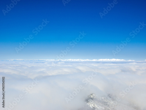 Sea of clouds and snowy peaks in a distance (Yokoteyama, Nagano, Japan) photo