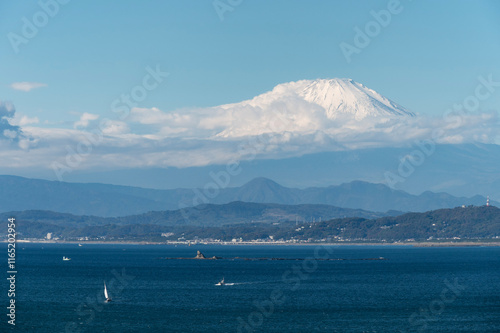 Sunny Day at Kamakura and Mount Fuji from afar with Enoshima Island in the foreground, Kanagawa, Japan photo