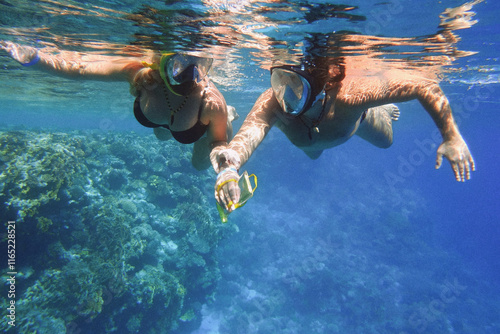 Fényképezés happy couple snorkeling in a wonderful coral reef
