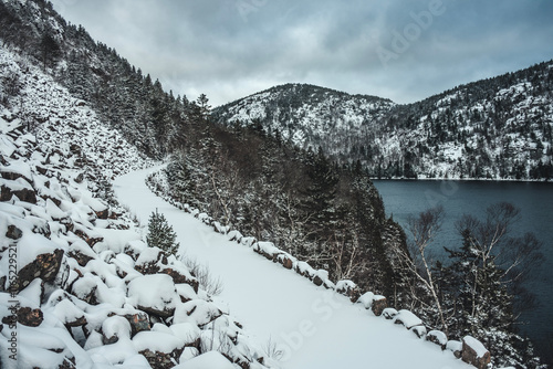 Snow covered carriage trail in winter in Acadia National Park photo