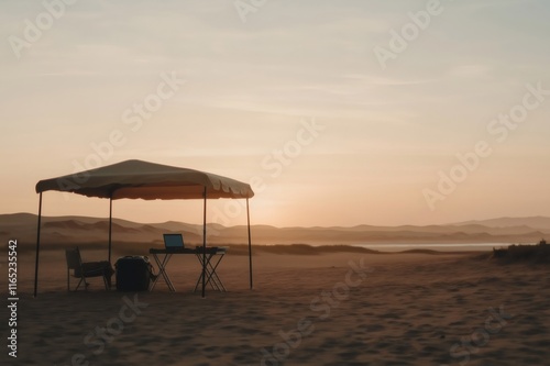 Digital nomad working remotely on the beach at sunset under canopy