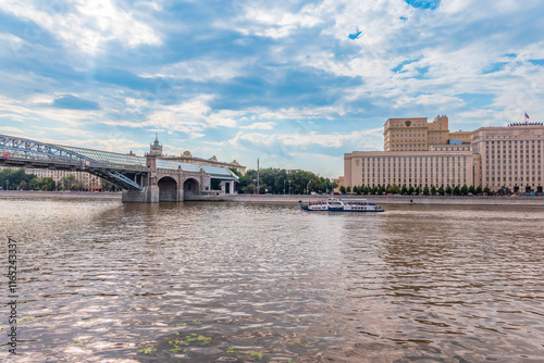 View of the Ministry of Defence of Russian Federation, and Moscow river embakment with cruise ships at sunset. photo