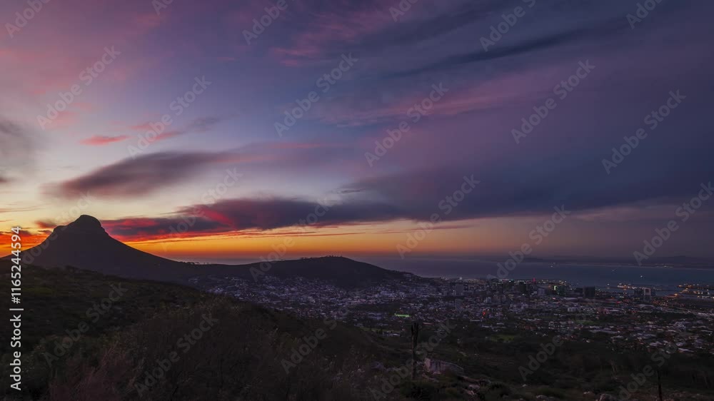 Sunset at Cape Town, South Africa time lapse at dusk with purple and colorful skies to the east of the city, Lion's Head peak in horizon Sunset at Cape Town, South Africa time lapse at dusk with purple and colorful skies to the east of the city, Lion's Head peak in horizon