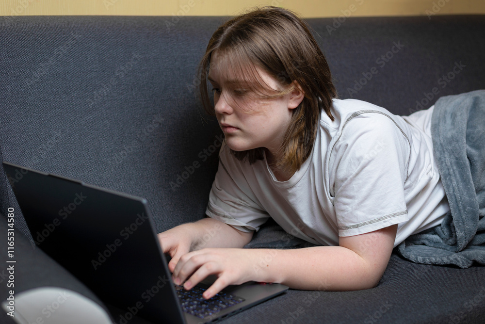 Smiling young woman using laptop, sitting on couch at home, beautiful girl shopping or chatting online in social network, having fun, watching movie, freelancer working on computer project Smiling young woman using laptop, sitting on couch at home, beautiful girl shopping or chatting online in social network, having fun, watching movie, freelancer working on computer project