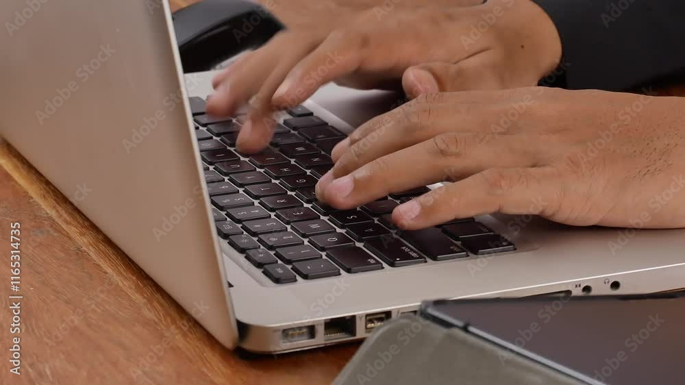Close-up of caucasian male hands typing on laptop keyboard at office desk. Unrecognizable adult African man working on computer indoors. Unknown afro businessman surfing the Internet online. Close-up of caucasian male hands typing on laptop keyboard at office desk. Unrecognizable adult African man working on computer indoors. Unknown afro businessman surfing the Internet online.