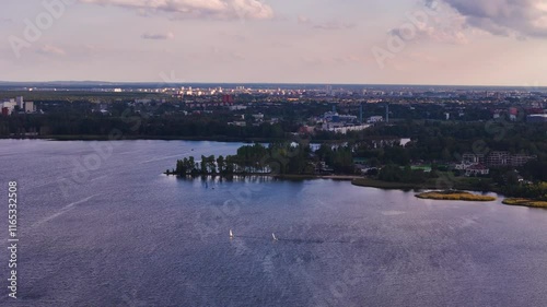 Scenic tracking left of Kisezers Lake in Latvia, calm water surrounded by green nature and serene beauty with cloud shadows on landscape photo