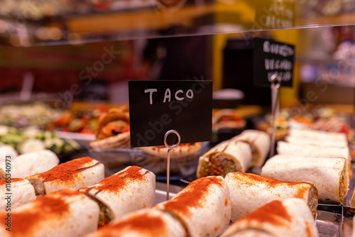 Fresh tacos on display at a food market photo