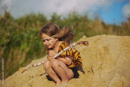 Cute baby dressed in the clothes of primitive people photo