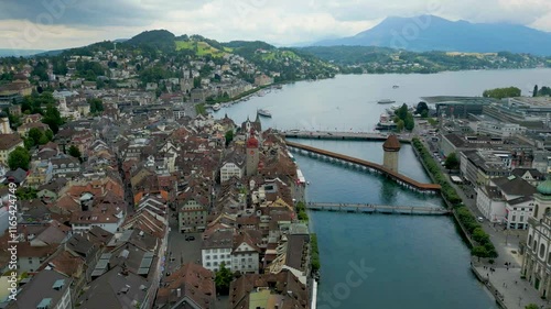 4K Drone Video of the Chapel, Seebrücke, Rathaussteg Bridges on the Reuss River as it flows from Lake Lucerne in Lucerne, Switzerland photo