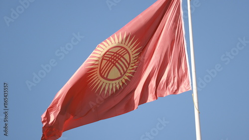 Kyrgyzstan flag is waving in Ala-Too Square photo