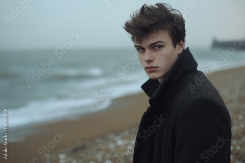 Young Man Stares Into Distance on Foggy Beach Seaside Landscape