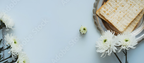 minimalistic composition of matzah bread and delicate white flowers, symbolizing purity and the essence of passover