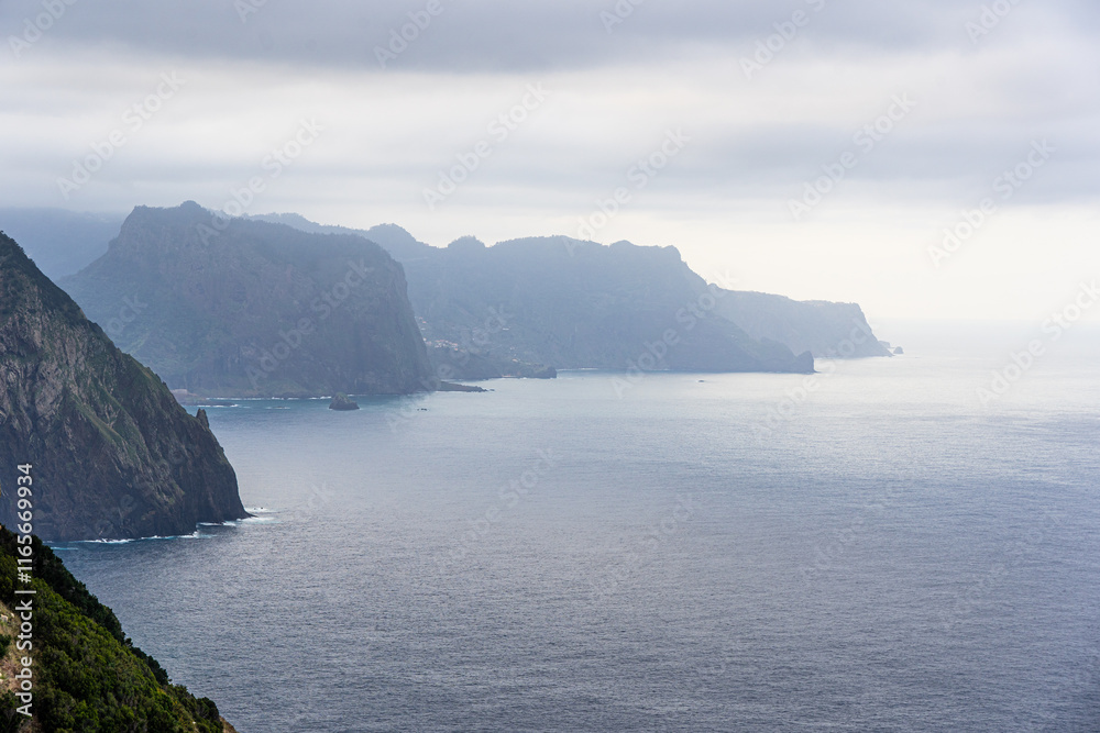 Panoramic View from São Lourenço Viewpoint Capturing the Majestic Cliffs and Seascape of Canical, Portugal on a Cloudy Day Panoramic View from São Lourenço Viewpoint Capturing the Majestic Cliffs and Seascape of Canical, Portugal on a Cloudy Day