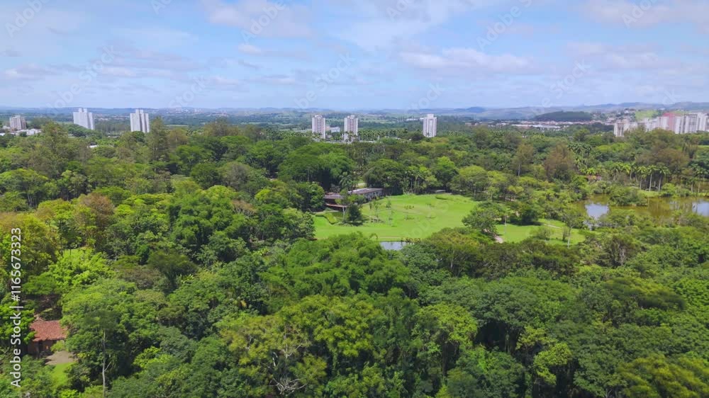 aerial view of a park near downtown of Sao Jose dos Campos, SP. With the city skyline and buildings at distance