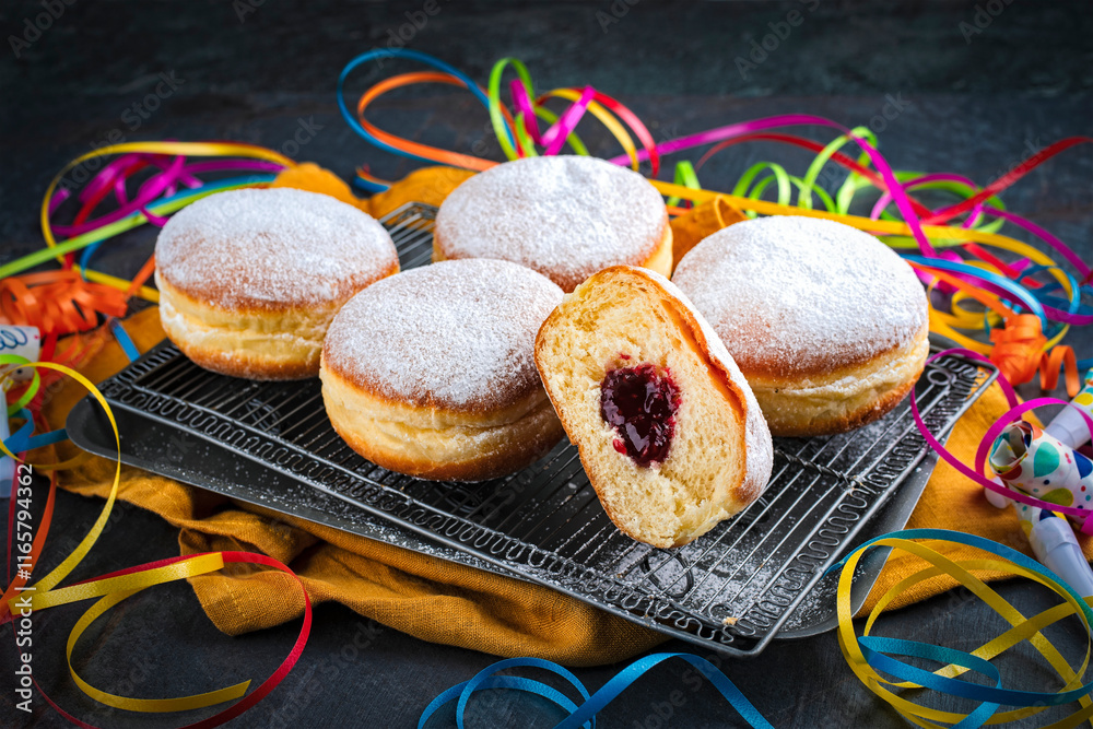 Naklejka premium Authentic traditional German festive Berliner Krapfen - jam doughnut with icing sugar and carnival party decoration