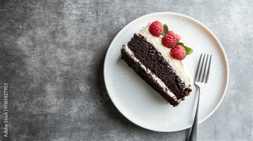 Delicious chocolate cake slice with fresh raspberries on a white plate