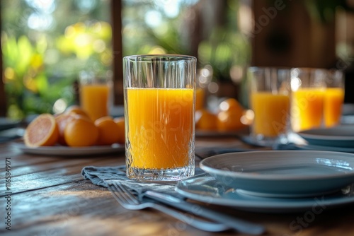 Freshly squeezed orange juice served with slices on a beautifully arranged ta...